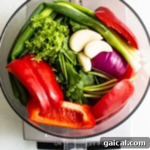 Fresh vegetables in a food processor, prepped for salsa.