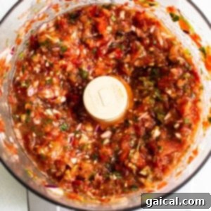 Salsa ingredients blending in a food processor.