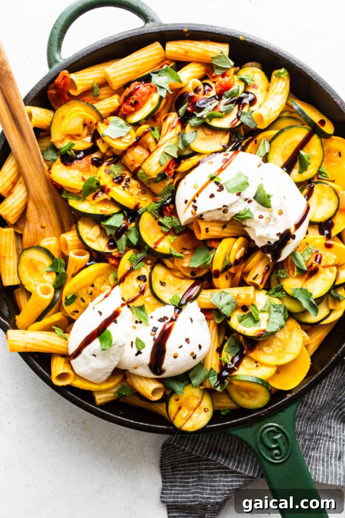 Vibrant Summer Squash Pasta 2 Summer squash pasta in a skillet, garnished with fresh herbs and a drizzle of balsamic glaze.