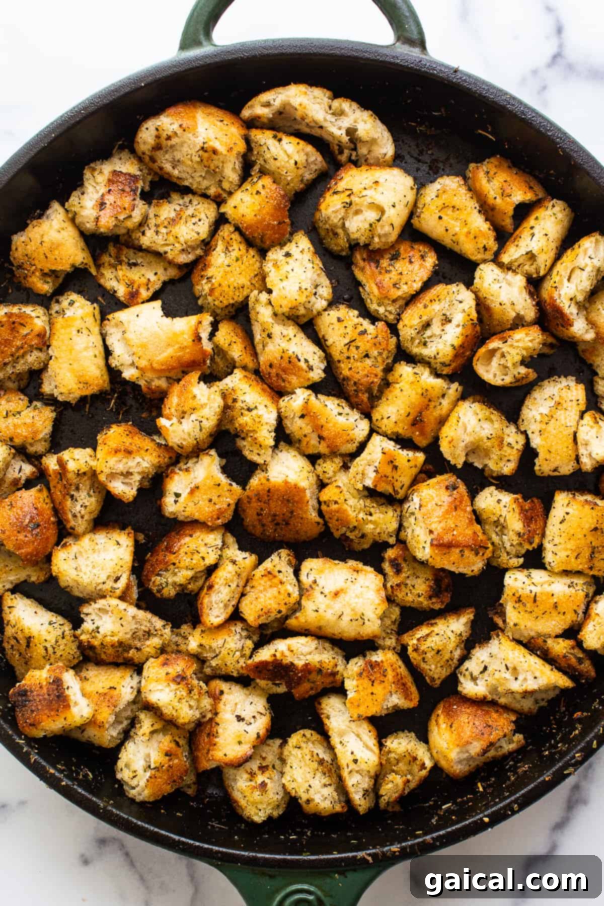Perfect Pan-Fried Croutons A close-up of delicious homemade croutons in a cast iron skillet, golden brown and perfectly seasoned, ready to elevate any dish.