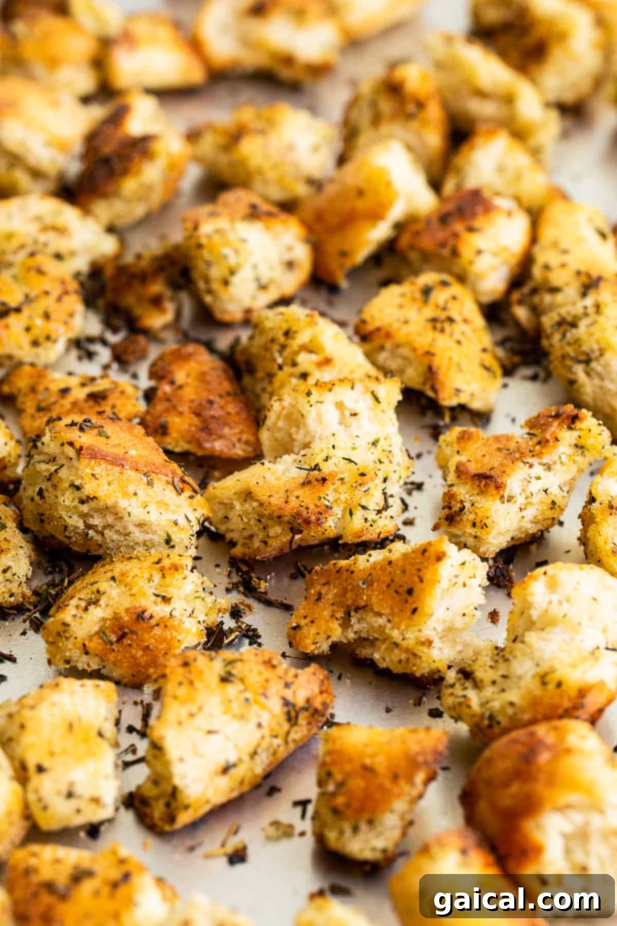 Cooling Homemade Croutons Freshly pan-fried homemade croutons scattered on a baking sheet, cooling to achieve their perfect crispy texture.