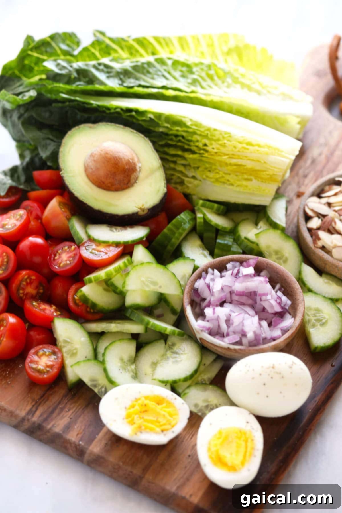 lettuce and assorted fresh vegetables on a cutting board