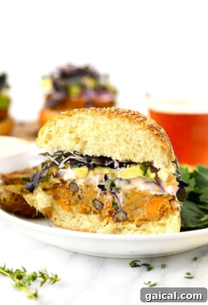 Delicious quinoa sweet potato burger with fresh toppings on a wooden board