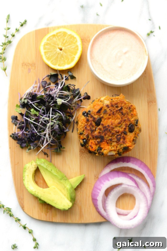 Sweet potato black bean burgers cooking in a skillet, developing a crispy crust