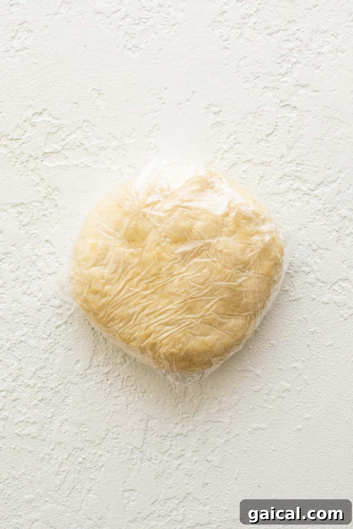 Savory Beef and Sweet Potato Empanadas 3 Homemade empanada dough, freshly prepared and wrapped in plastic wrap, resting before use.