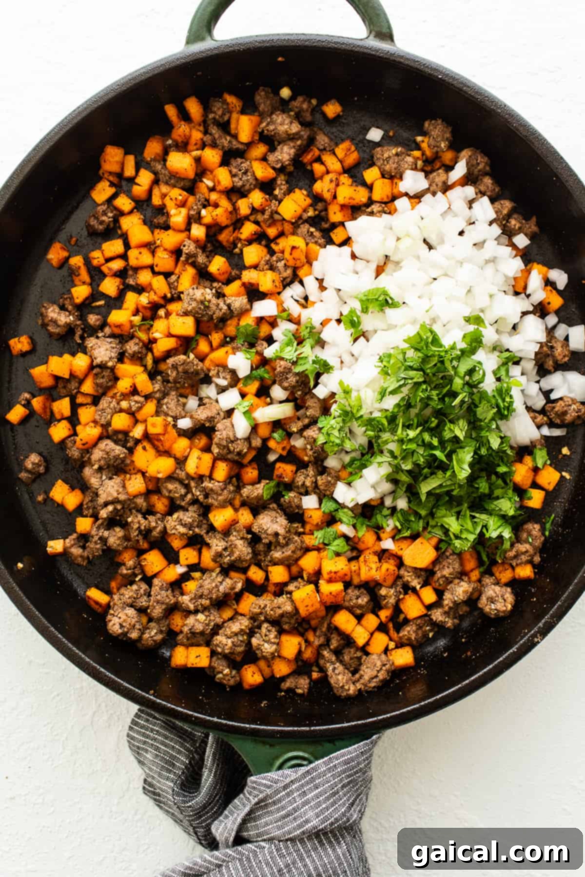 Savory Beef and Sweet Potato Empanadas 6 A large skillet filled with cooked ground beef, diced sweet potatoes, and aromatic spices.