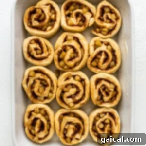 Apple cinnamon rolls arranged in a baking dish.