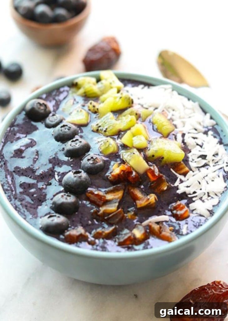 Vibrant Blueberry Smoothie Bowl 2 A delicious Blueberry Smoothie Bowl topped with kiwi and granola.