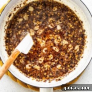 Hot honey mixture simmering in a pan.