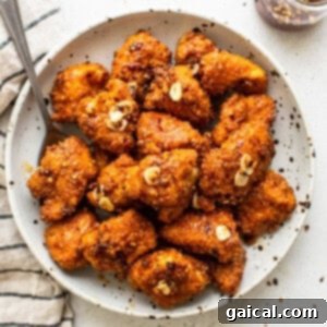 Sweet Heat Glaze 2 Hot honey chicken poppers in a bowl, coated in delicious sauce.