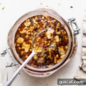 Hot honey sauce in a small bowl with a spoon.