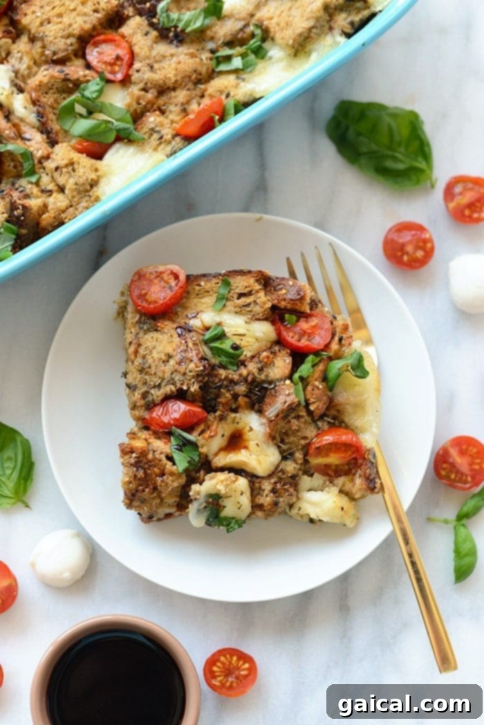 Caprese Sunrise Strata 5 A serving of Caprese Egg Bake on a plate, garnished with extra fresh basil and a drizzle of balsamic glaze, ready to be enjoyed.