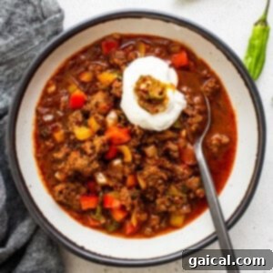 A vibrant bowl of Texas chili, brimming with rich colors and textures, ready to be savored.
