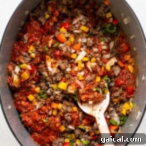 All the ingredients for Texas chili simmering together in a large pot.