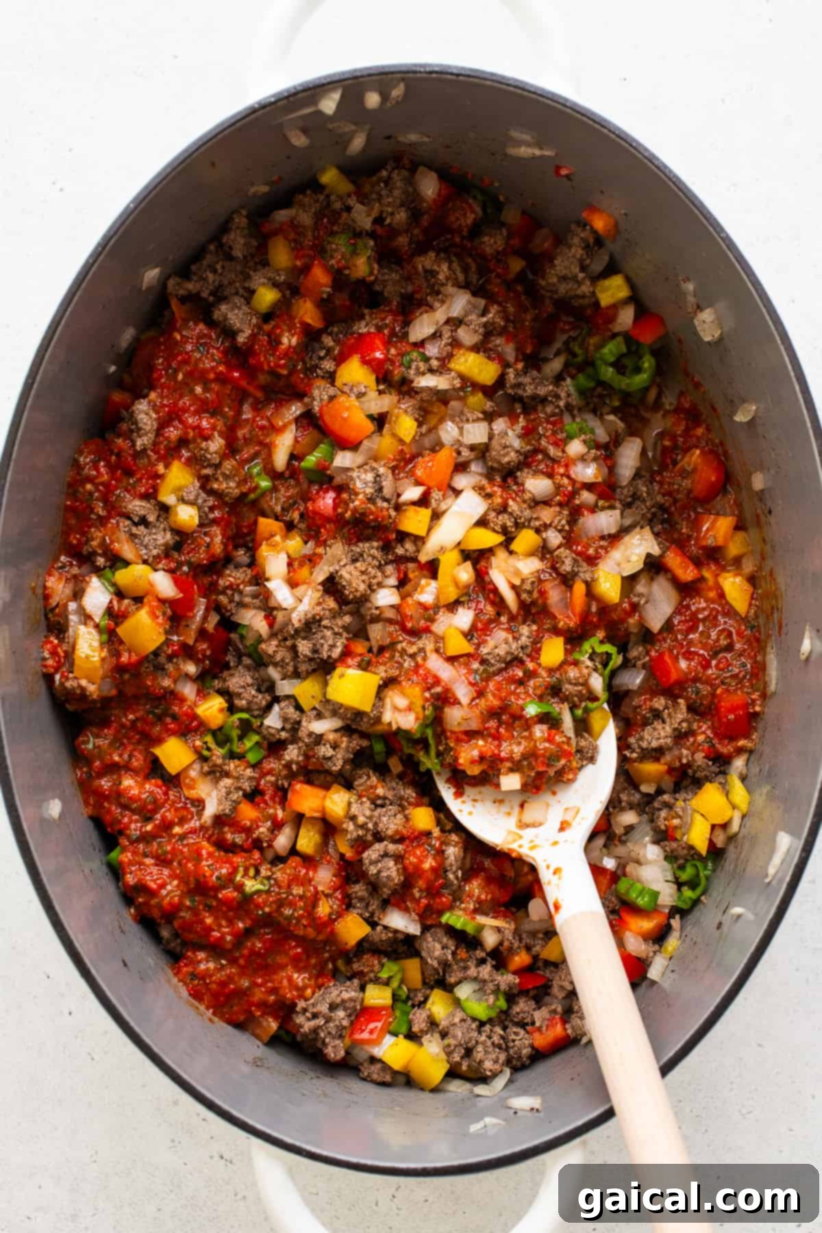 Hearty Texas Red 5 All the vibrant ingredients for the Texas chili simmering together in a large pot, creating a rich and flavorful stew.