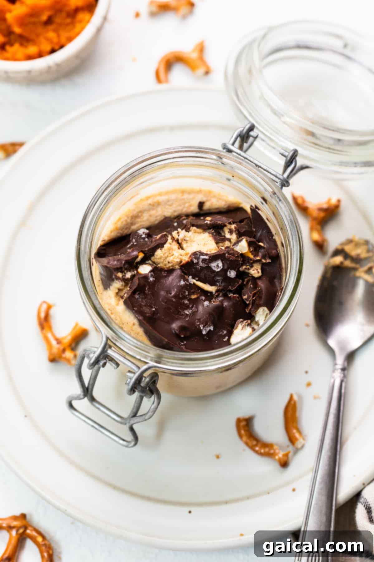 Pumpkin Mousse Ready to Serve Pumpkin mousse in a jar with a beautiful chocolate pretzel topping.