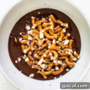 Whipped Pumpkin Spice Dream 6 A white bowl filled with chocolate and pretzels.