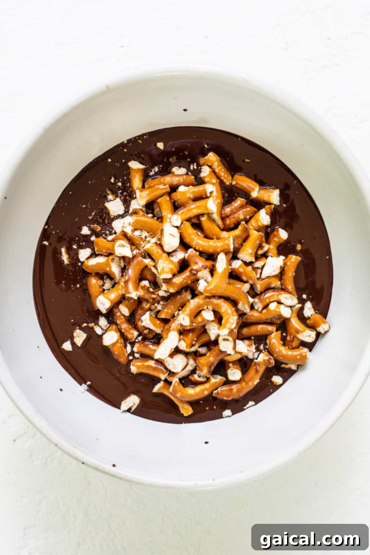Chocolate Pretzel Topping A bowl of rich chocolate and crushed pretzels, ready for topping the mousse.