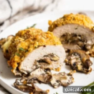A delectable stuffed pork chop plated and garnished, ready to be enjoyed.