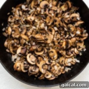 Cooking sliced mushrooms in a skillet until golden and caramelized.