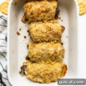Freshly baked stuffed pork chops in a casserole dish, ready to rest.