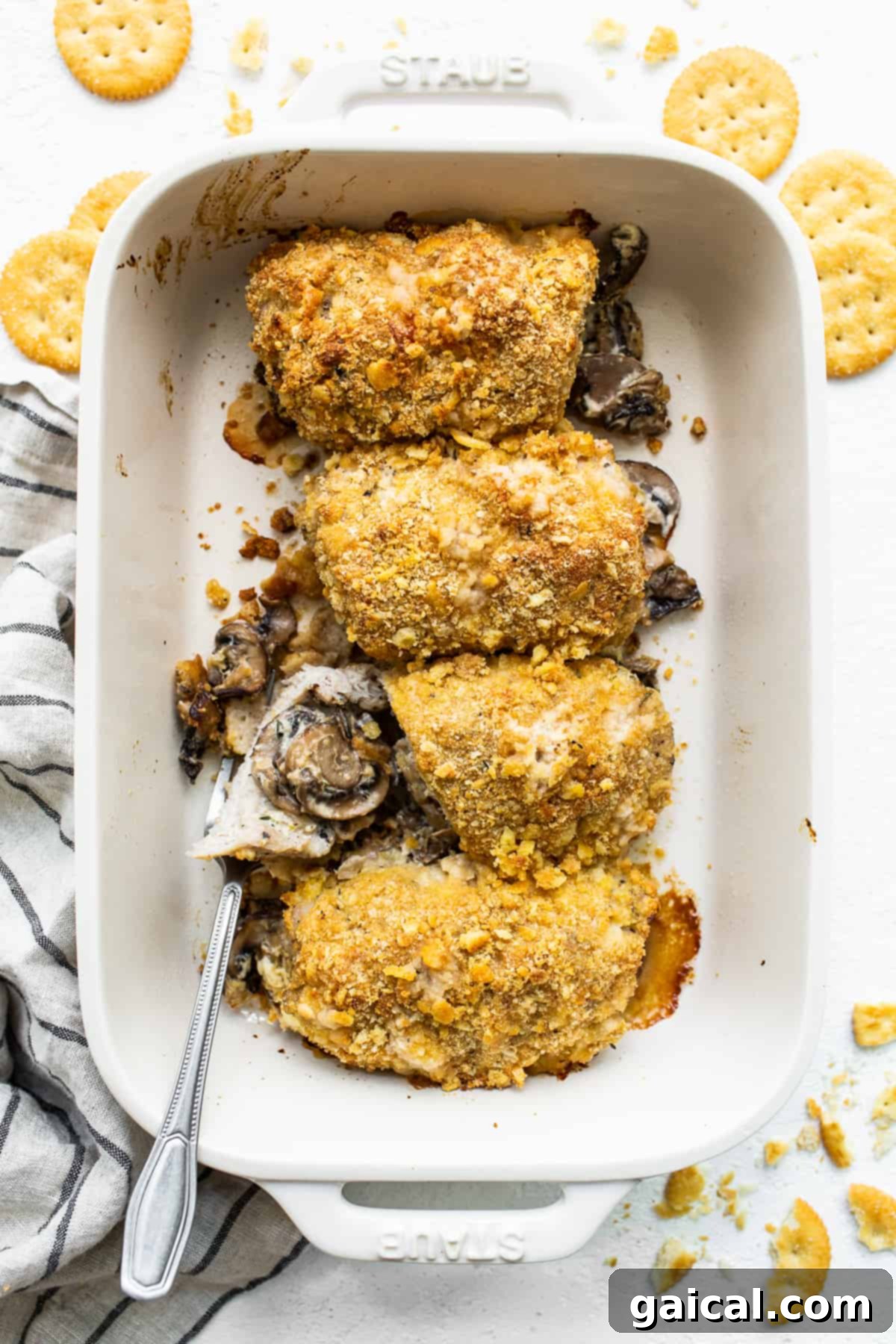 Perfectly Baked Stuffed Pork Chops in a Casserole Dish Four golden-brown stuffed pork chops resting in a casserole dish after baking.