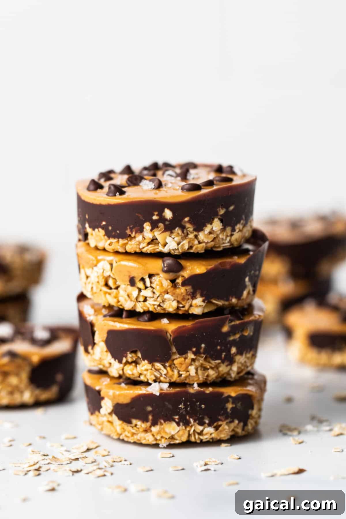 Fit Foodie Cooking March 2023 Session 4 Four delicious no-bake peanut butter oat cups stacked high, ready to be enjoyed as a perfect snack.