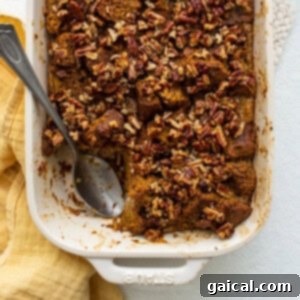 Baked pumpkin bread pudding in a casserole dish, ready to be served, showcasing its golden crust and tender interior.