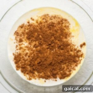 Decadent Pumpkin Bread Pudding 4 whisking eggs and spices.