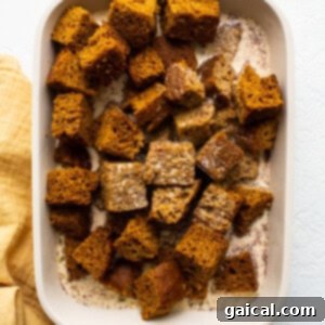Decadent Pumpkin Bread Pudding 5 pumpkin bread pieces in egg.