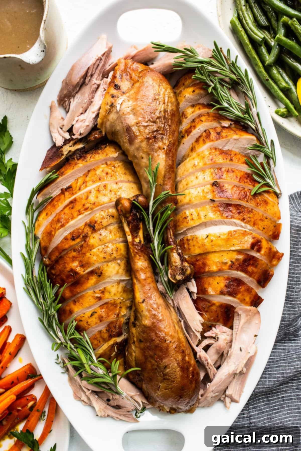 The Ultimate Thanksgiving Turkey Guide 10 Beautifully sliced Thanksgiving turkey arranged on a elegant platter, ready to be served, highlighting its moist and flavorful texture.