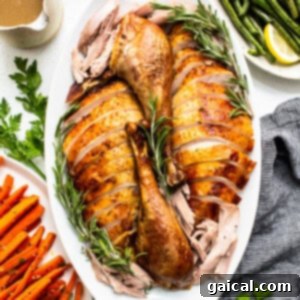 Beautifully sliced turkey presented on a serving platter, ready for the Thanksgiving table.