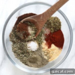 The Ultimate Thanksgiving Turkey Guide 5 A small bowl filled with homemade flavorful turkey seasoning, a blend of dried herbs and spices, ready for use.