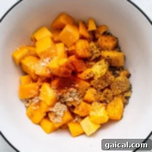 A bowl filled with chopped squash and spices, ready for marination.