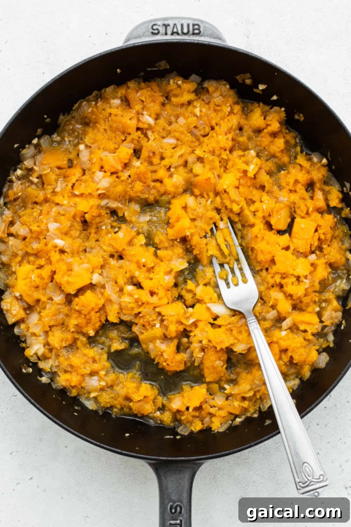 Velvety Butternut Squash Risotto 4 The simple yet effective technique of smashing softened butternut squash directly in the pan with the back of a fork to create a creamy and flavorful base for the risotto.