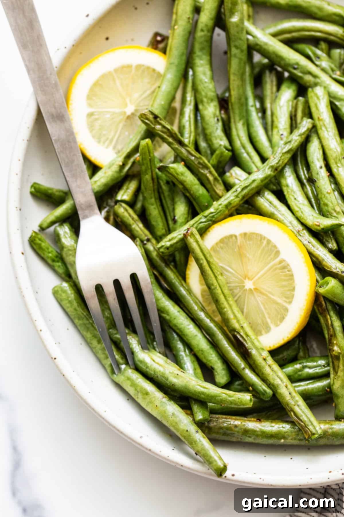 Garlic Parmesan Roasted Green Beans 6 Roasted green beans in a serving dish, showcasing their charred spots and vibrant color.