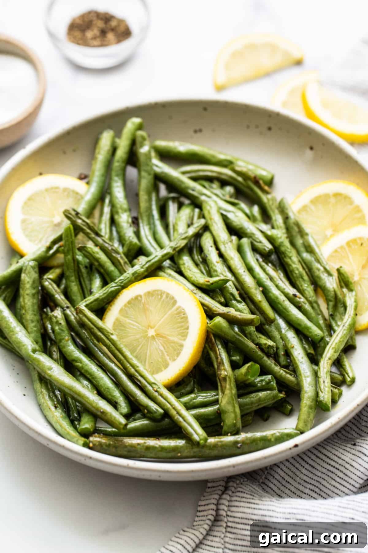 Garlic Parmesan Roasted Green Beans 7 Roasted green beans elegantly presented in a serving dish, perfect for a holiday gathering.