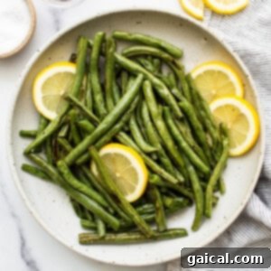 Green beans in a serving dish, highlighting their roasted texture.