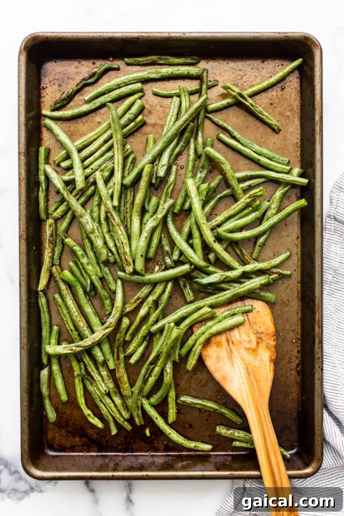 Garlic Parmesan Roasted Green Beans 5 Crispy roasted green beans on a baking sheet, fresh out of the oven.