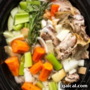 Homemade turkey broth in a crockpot, rich and golden.