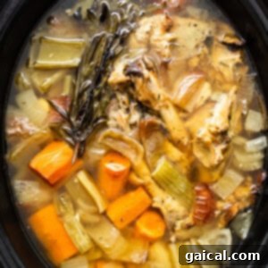 Homemade turkey stock in the slow cooker after cooking, with solids removed.