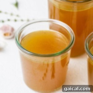 Homemade turkey stock stored in a glass jar.