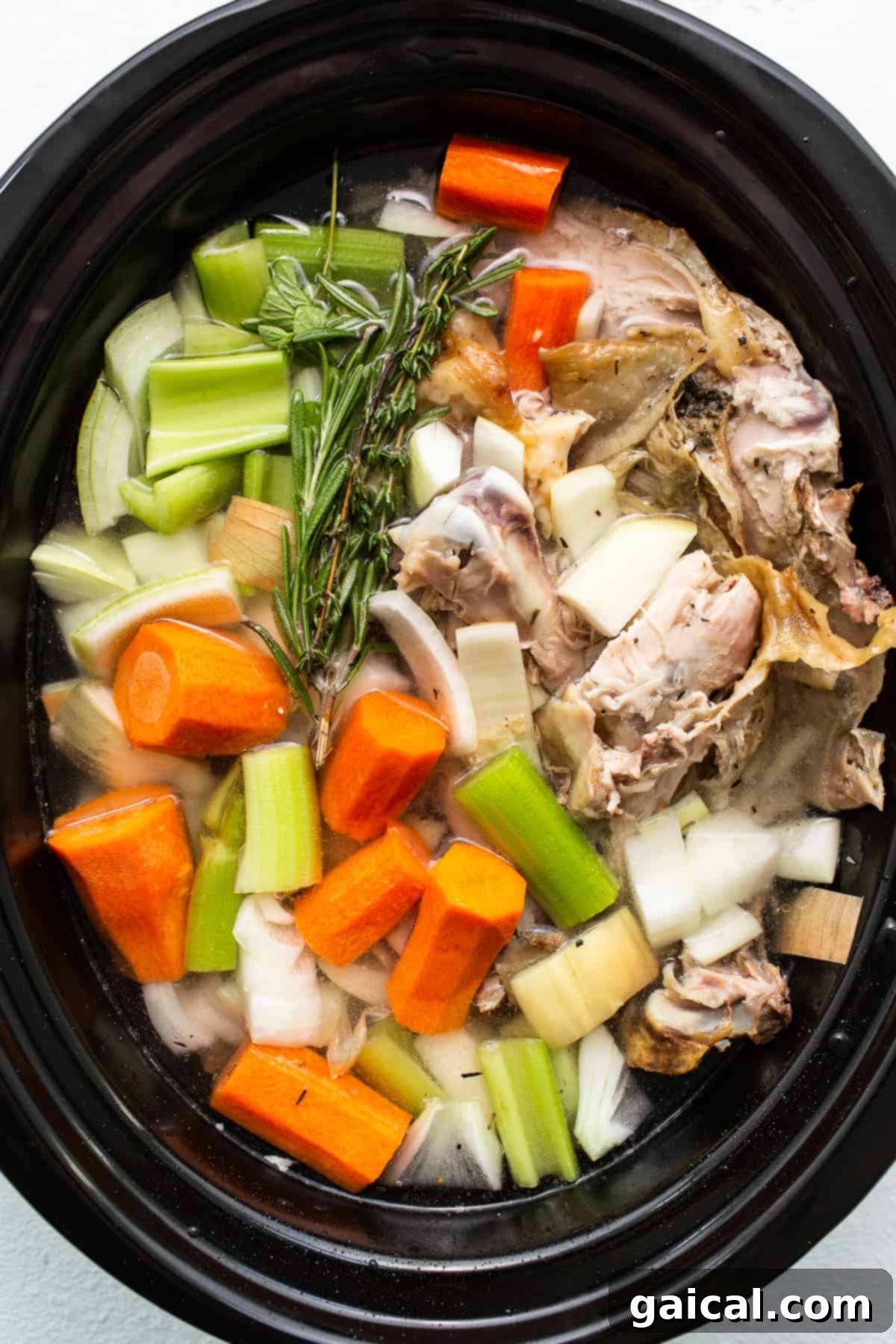 Slow Simmered Turkey Broth 5 Turkey stock simmering gently in a slow cooker, filling the kitchen with rich aromas.