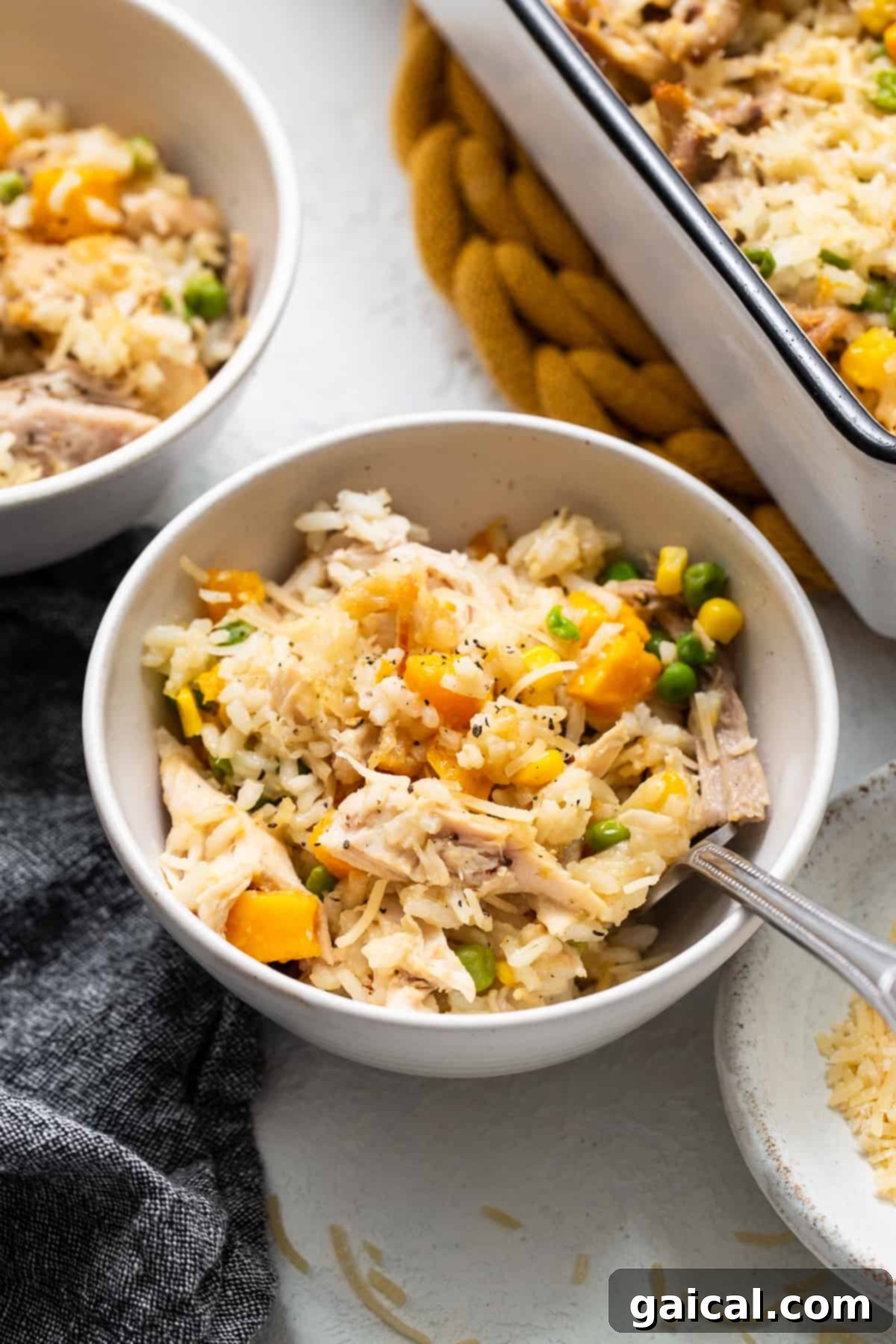 A comforting bowl of turkey casserole with a spoon, inviting you to take a bite.