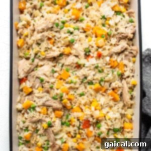Mixed chicken fried rice ingredients in a baking dish.
