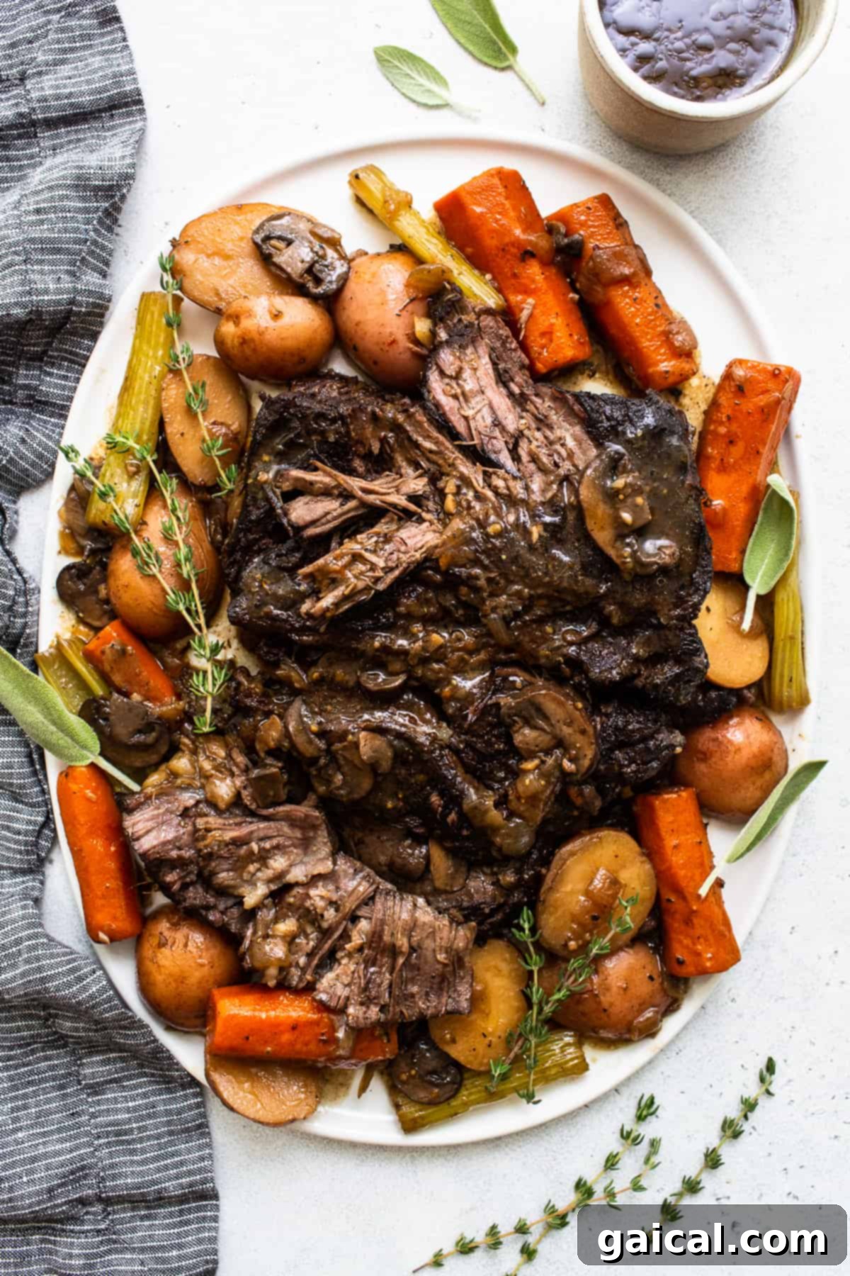 The Ultimate Dutch Oven Pot Roast: Tender, Juicy, and Flavorful Comfort Food A beautifully plated pot roast, showcasing tender shredded beef, carrots, and potatoes, topped with fresh herbs and a rich gravy. A truly satisfying comfort meal.