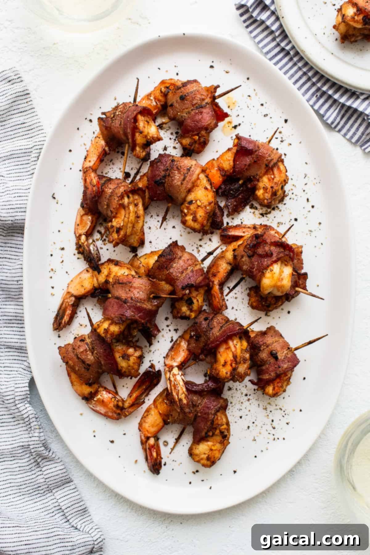 Ultimate Bacon Wrapped Shrimp: Juicy, Smoky & Easy Appetizer Bacon wrapped shrimp on a platter, elegantly arranged and ready to be served.