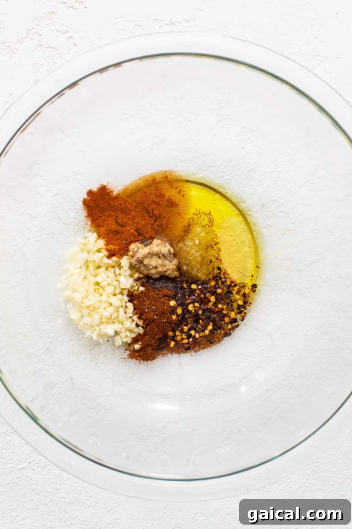 Fresh Marinade Ingredients for Flavorful Shrimp A vibrant array of fresh ingredients for a zesty shrimp marinade in a glass bowl.