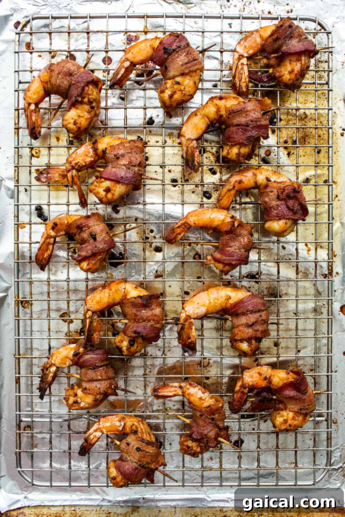 Crispy Bacon Wrapped Shrimp Fresh from the Oven Crispy bacon-wrapped shrimp skewers cooling on a wire rack after baking.