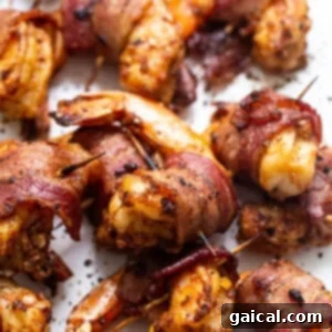 Close-up of crispy bacon-wrapped shrimp on a serving platter.